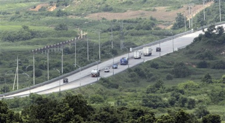 South Korean trucks enter the North Korea as North Korean military vehicles, right and left, escort them, as they are observed from the Dora Observation Post in Paju near the truce village of Panmunjom in the demilitarized zone (DMZ) that separates the two Koreas since the Korean War, north of Seoul, South Korea, Wednesday, July 14, 2010. Talks between North Korea and the American-led U.N. Command have been rescheduled for Thursday after Pyongyang abruptly canceled a meeting meant to discuss the sinking of a South Korean warship blamed on Pyongyang.  (AP Photo/Lee Jin-man)
